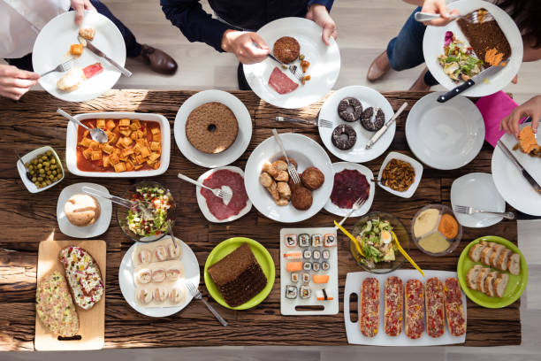 istock Group Of People Eating Food On Plate 975117976