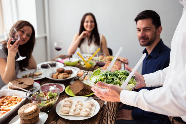istock Waiter Holding Bowl Of Salad 975117982