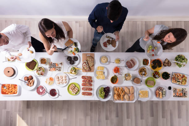 Group Of People Eating Fresh Healthy Food On Plate