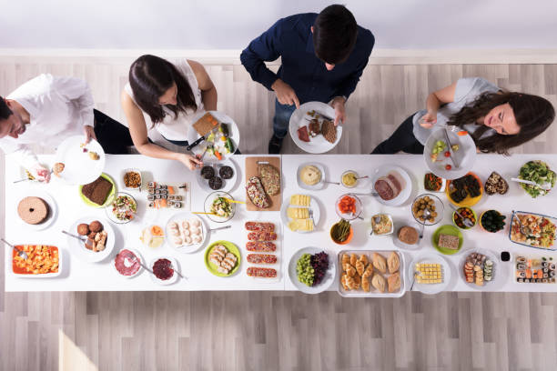 Group Of People Eating Fresh Healthy Food On Plate