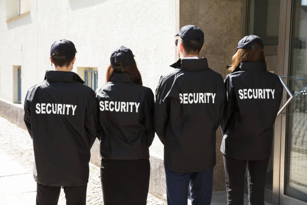 istock Rear View Of Security Guards Wearing Uniform 975118128