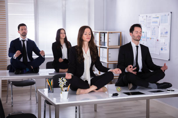 istock Businesspeople Meditating In Office 975123186