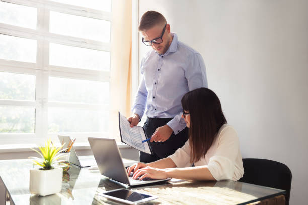 istock Businessman Showing Document To His Partner 975124152