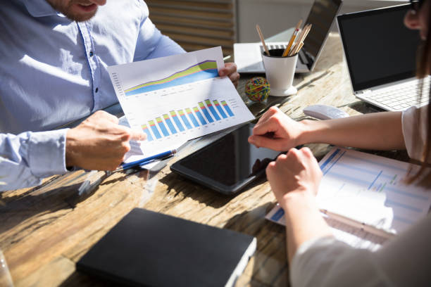 istock Businessman Showing Graph To His Colleague 975124230