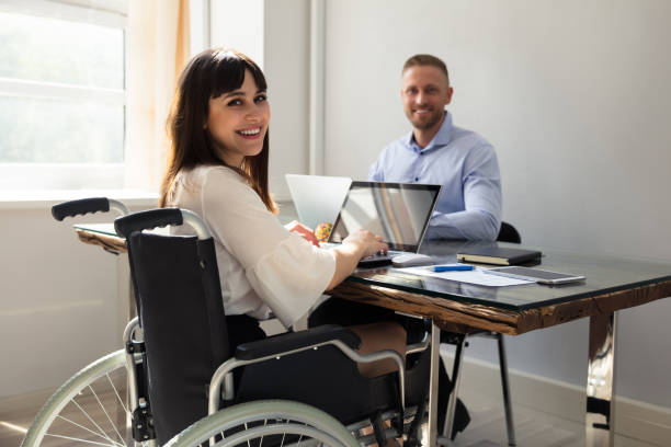 istock Happy Disabled Businesswoman Working On Laptop 975124344