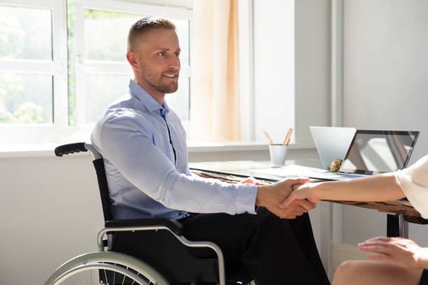 istock Disabled Businessman Shaking Hand With His Partner 975124400