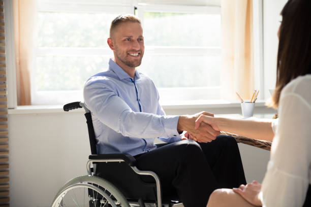 istock Disabled Businessman Shaking Hand With His Partner 975124448