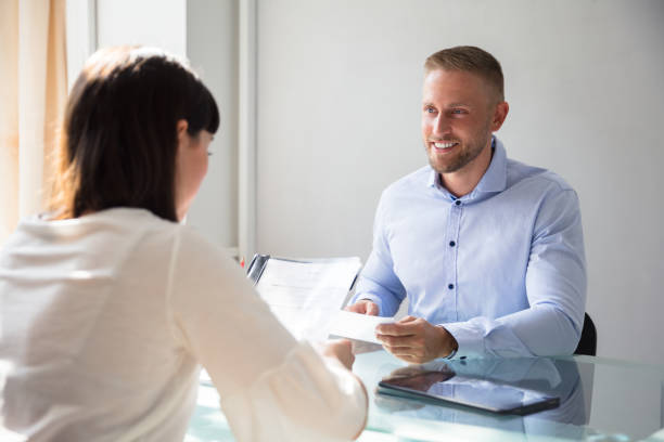 istock Businesswoman Interviewing Male Candidate 975124582