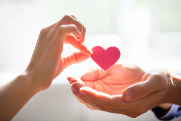 istock Woman Giving Heart On Man's Hand 975126334