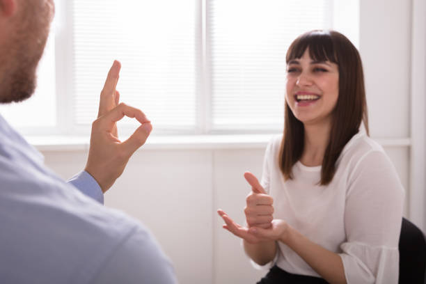 istock Young Woman And Man Talking With Sign Language 975126494