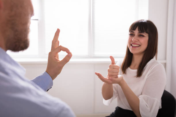 istock Young Woman And Man Talking With Sign Language 975126504