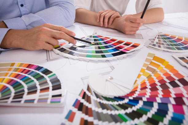 istock Two Architect Choosing Color From Various Colorful Swatches 975126690