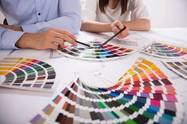 istock Two Architect Choosing Color From Various Colorful Swatches 975126722