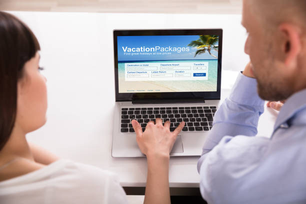istock Couple Searching Online Hotels On Laptop 975131424