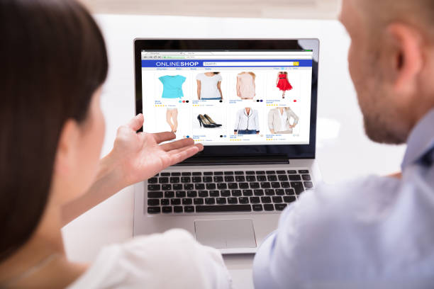 istock Couple Shopping Online On Laptop 975131438