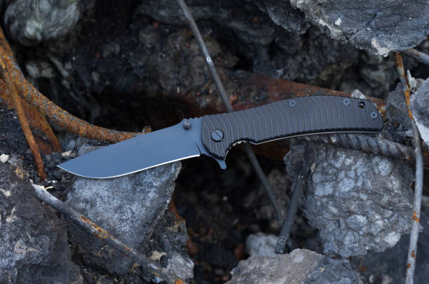 istock Black army knife. Knife on concrete. 975144336