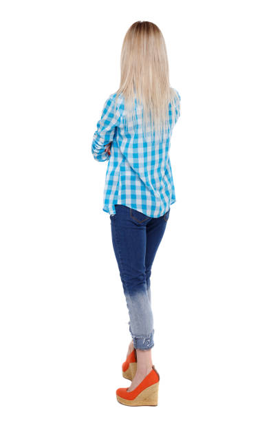 istock Back view of a woman in jeans. 975145452