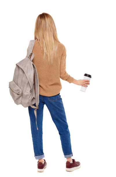 Back view of walking  woman  with coffee cup and backpack. backside view of person.  Rear view people collection. Isolated over white background. Blonde traveler drinks coffee.