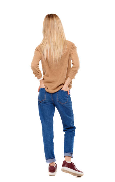 istock Back view of a woman standing. 975165604