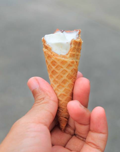istock Hand Holding Ice Cream Cones with Chocolate 975183488