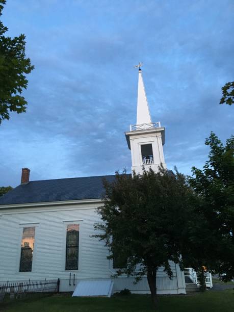 istock Church steeple at dusk on a cloudy evening in Maine 975183656