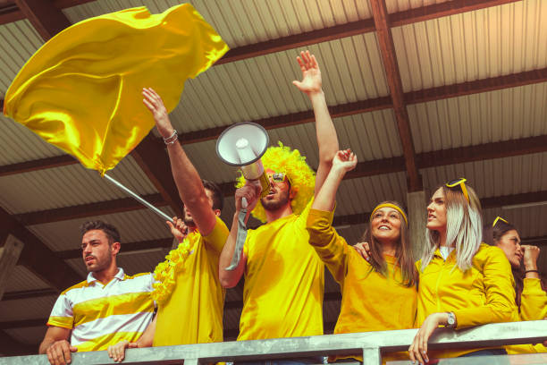 istock group of fans dressed in yellow color 975196614