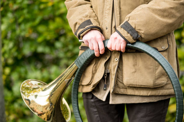 istock French horn band held in hands by a hunter on Saint Hubertus Day, 05/11/2017, De Moer, The Netherlands 975196924