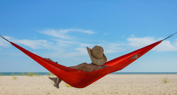istock Relaxed woman lying in a hammock 975208368