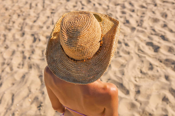 istock Woman in summer vacation wearing straw hat 975208400