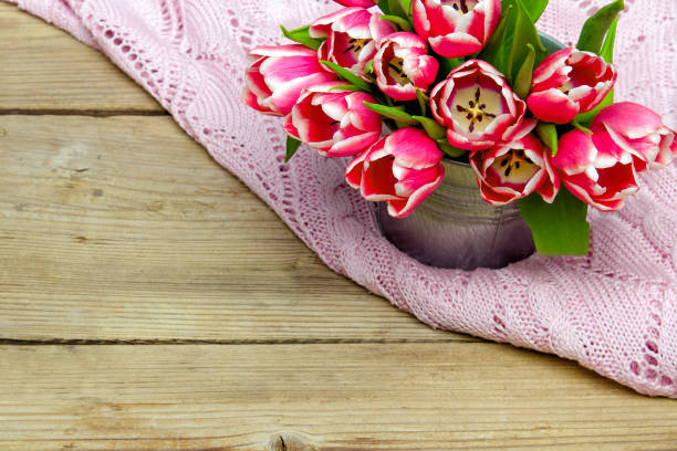 istock Pink tulip bouquet on retro wooden background, copy space 975210402