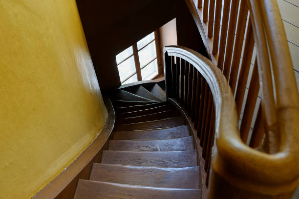 istock Old wooden round staircase spiraling 975212922