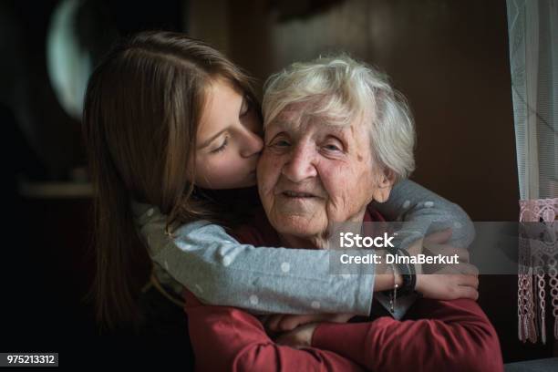 A Little Girl Hugs Her Grandmother Stock Photo - Download Image Now - Grandmother, Embracing, Family