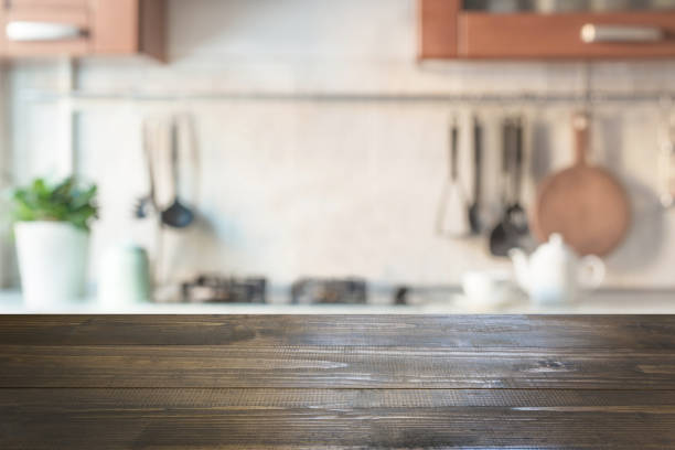 istock Blurred abstract background. Modern kitchen with tabletop and space for display your products. 975215790