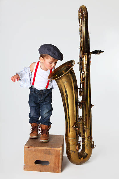 little boy and saxophone  flat cap stock pictures, royalty-free photos & images