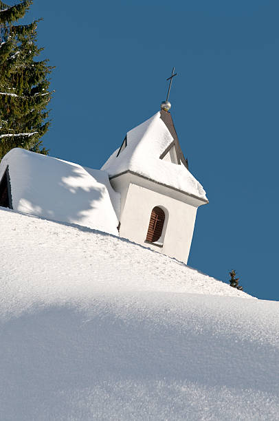 istock White Chapel Hiding on Snowy Pile 97522036