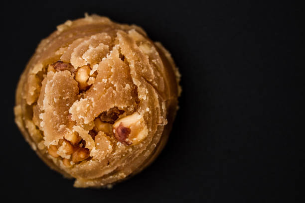 Traditional Turkish sweet dessert halva with nuts on black tray