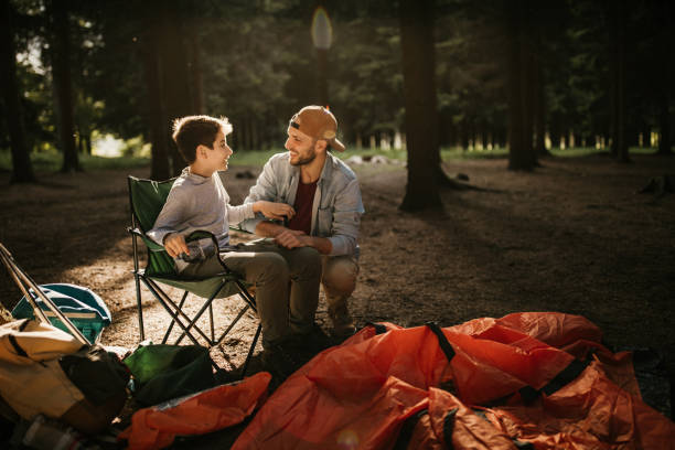 istock Father and son resting in forest of long walk 975234900