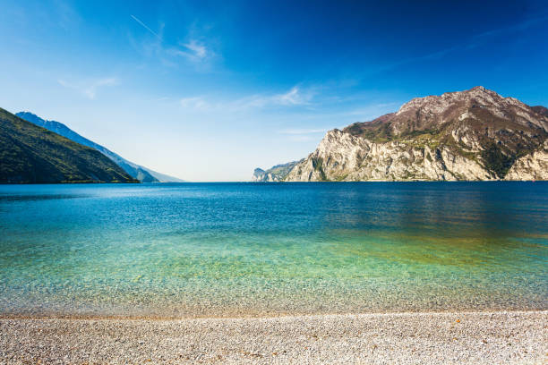 Mountains and transparent water of lake Garda in Torbole