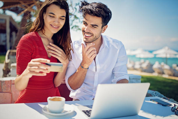 istock Couple is shopping online/making reservation on the beach 975241816