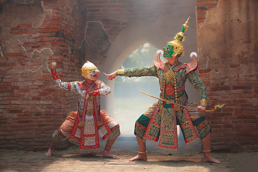 Hanuman (monkey god) fighting Thotsakan (giant) in Khon or Traditional Thai Pantomime as a cultural dancing arts performance in mask dressed based on the character in Ramakien or Ramayana Literature.