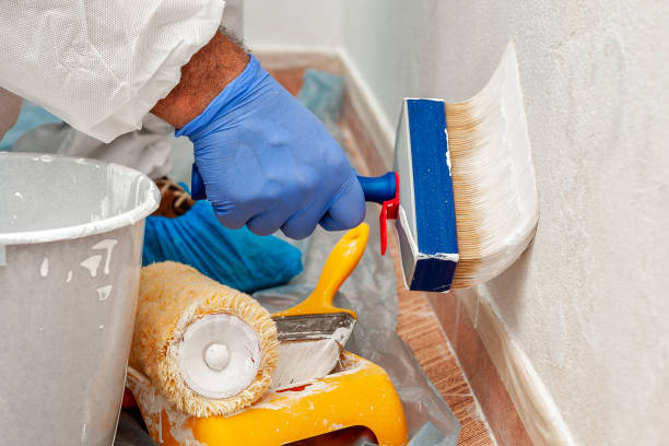istock House painter at work painting a wall with a brush 975250858