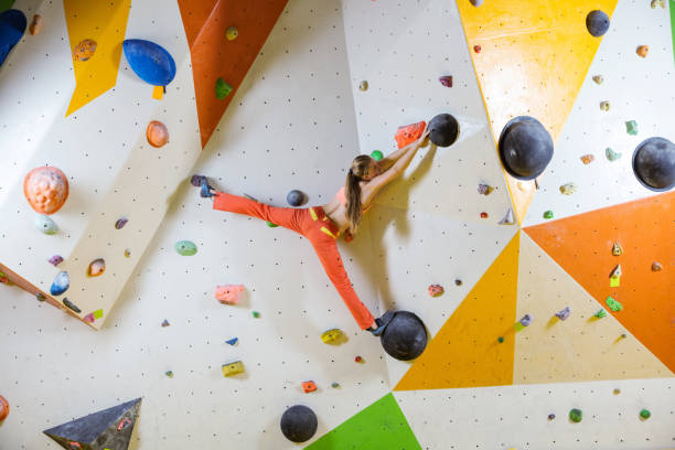 istock Young woman climbing challenging bouldering route 975262010