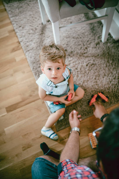 istock Uncle And Nephew Playing With New plastic block Toys 975290052