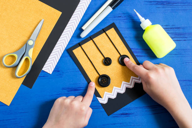 istock Child makes card to Halloween. Step 5 975294926