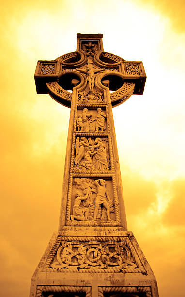 istock Medieval Celtic Cross with sunset colors in Irish cemetery 97530465