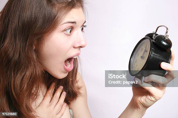 A Girl Holding Alarm Clock With Alarmed Expression Stock Photo - Download Image Now - Adult, Adults Only, Alarm Clock