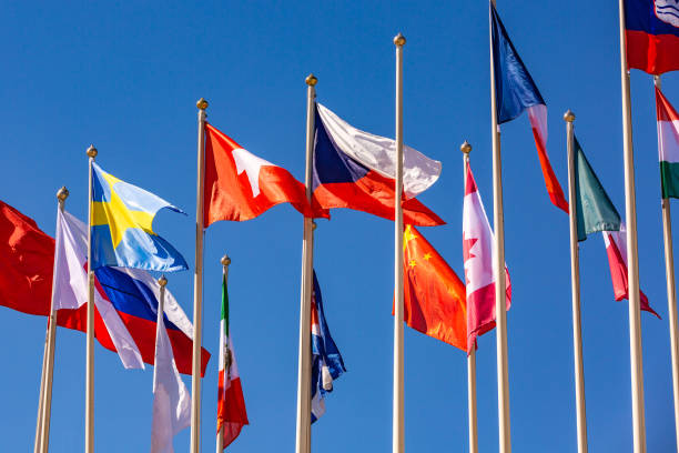 istock Flags of different countries flutters in the wind against 975321910
