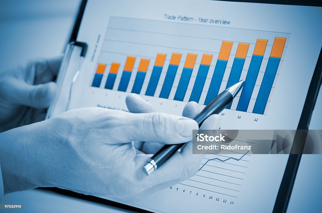 Person showing a good and successful annual report Businessman hand showing growing chart on annual report, good business growth. Achievement Stock Photo