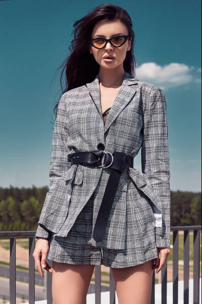 istock Charming bright brunette wearing woolen checkered business suit 975340562