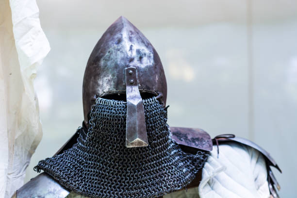 istock Medieval old knight helmet and chain mail for protection in battle 975384122